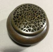 A small bronze lidded round censer