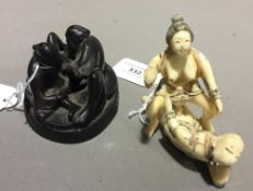 A Japanese carved bone erotic group of an amorous couple,