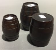 Three graduated turned treen barrel boxes and covers