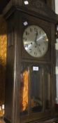 An early 20th century oak framed wall clock