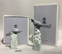 Two boxed Lladro animals, a goat and a tiger,