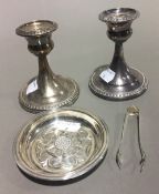 A pair of silver candlesticks,