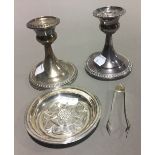 A pair of silver candlesticks,