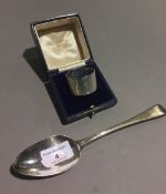 A Georgian silver spoon and a silver napkin ring