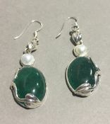 A pair of silver and jade earrings