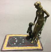 A cold painted bronze figure of a girl with a panther