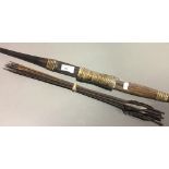 An early 20th century Indonesian bow and thirteen arrows,