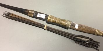 An early 20th century Indonesian bow and thirteen arrows,