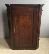 A Georgian inlaid oak corner cabinet