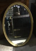 An oval gilt framed mirror