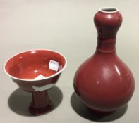 A Chinese red ground stem cup and a red ground vase