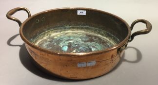 A twin handled copper pan