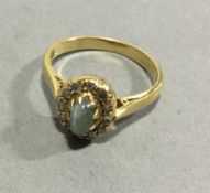 An antique 18 ct yellow gold ring set with twelve old cut diamonds with star cut green sapphire