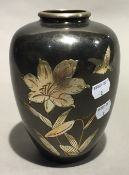 An Oriental brass vase with white metal overlay,