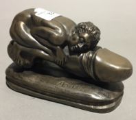 An erotic bronzed figure modelled riding a phallus