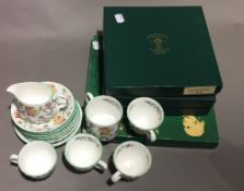 A Mintons part tea/coffee set and three boxed collectors' plates