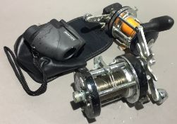 Two ABU fishing reels and a pair of binoculars