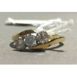 An 18 ct gold three stone diamond ring (4 grammes total weight)