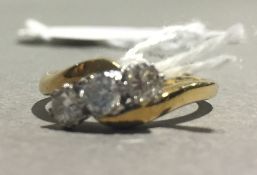 An 18 ct gold three stone diamond ring (4 grammes total weight)