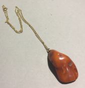 An amber pendant on an unmarked chain