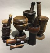 Eight turned lignum vitae and other treen pestles and mortars