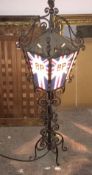 A wrought iron advertising standard lamp,