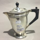 A silver hot water jug,