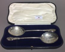 A cased pair of silver serving spoons