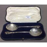 A cased pair of silver serving spoons