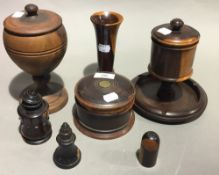 A turned lignum vitae tobacco box and cover together with other turned treen items