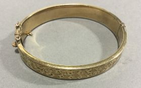 A 9 ct gold metal core engraved bracelet