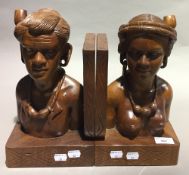 A pair of Eastern figurally carved bookends