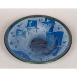 A Kosta Boda blue Art glass bowl, decorated with various stylised heads wearing top hats,