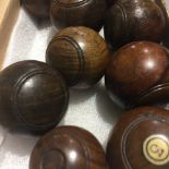 A set of nine turned treen carpet bowls