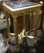 A gilt marble top table