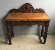 A Victorian carved oak side table