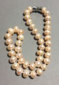 A pink pearl bead necklace