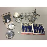 A quantity of small silver items, including a toast rack, a picture frame, etc.