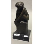 A bronze girl on a marble base