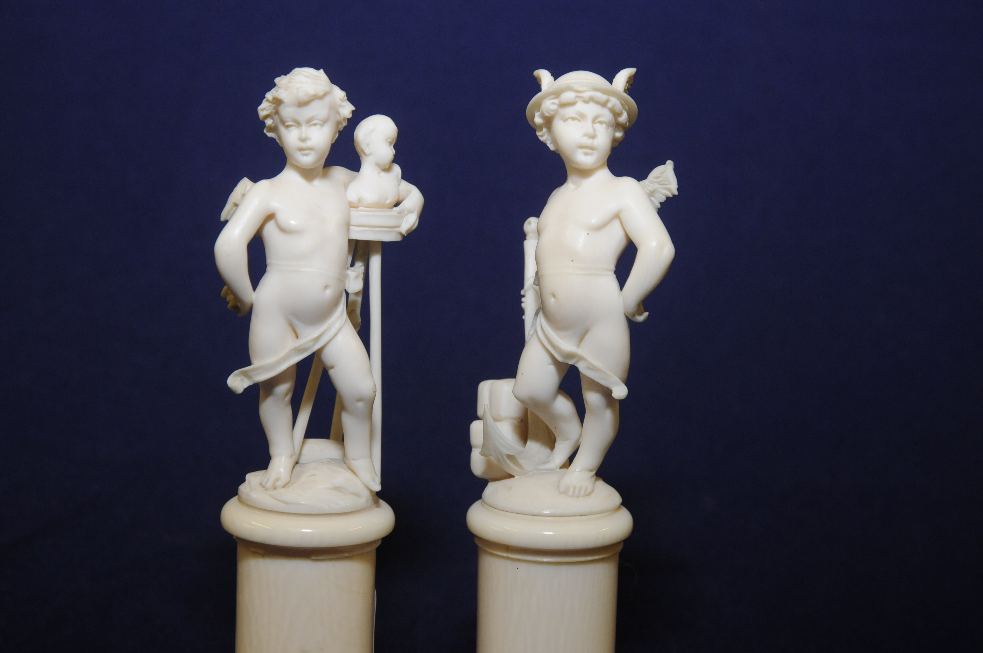 Pair of early 19th C French carved ivory figures of neo-classical form depicting winged cherubs in