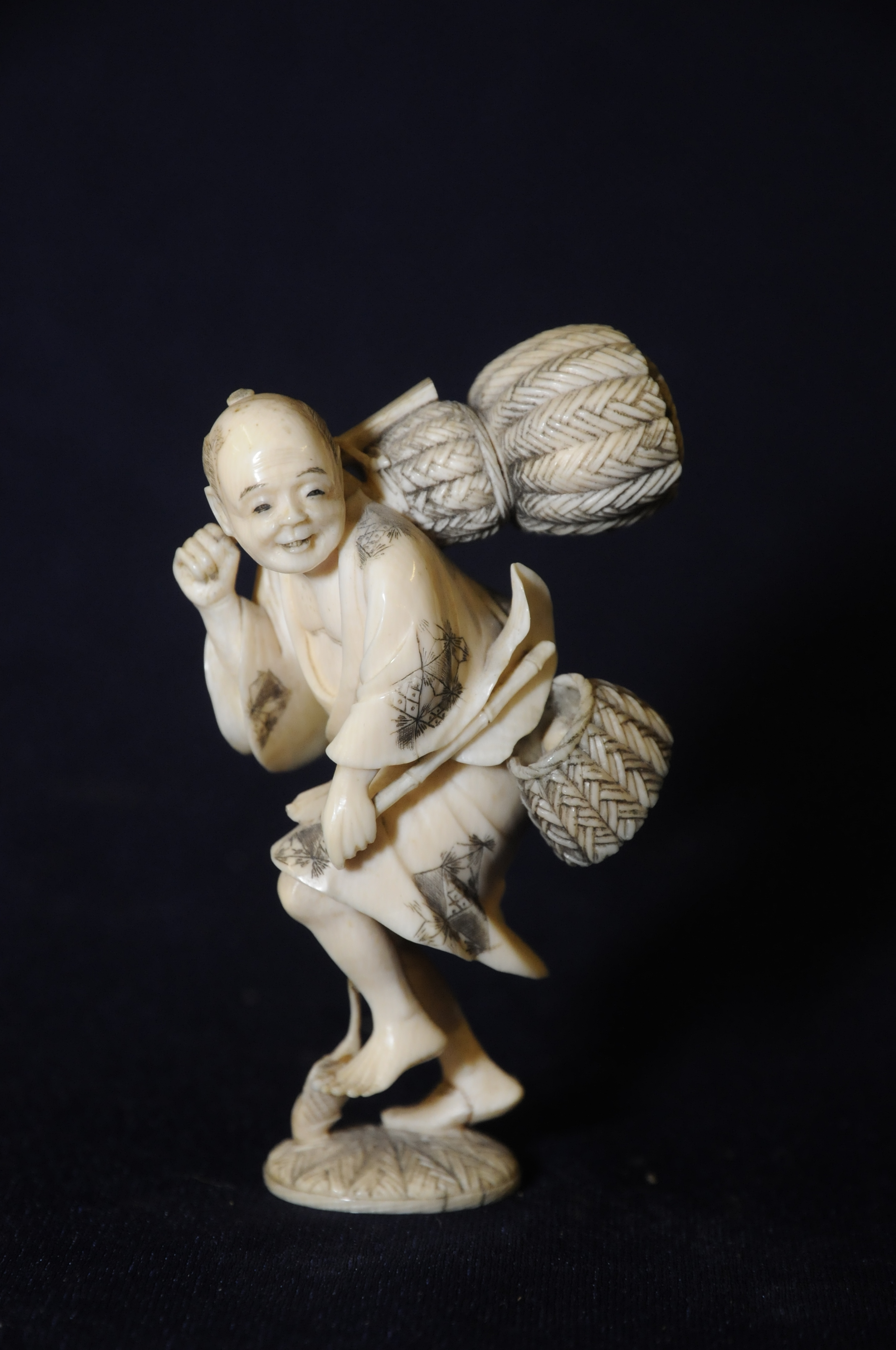 Mid 19th C Japanese carved ivory figure of a fisherman with insert cinnabar lacquer signature panel