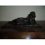 Bronze figure of a reclining lady in traditional dress on rectangular rug effect base (18cm x 10cm