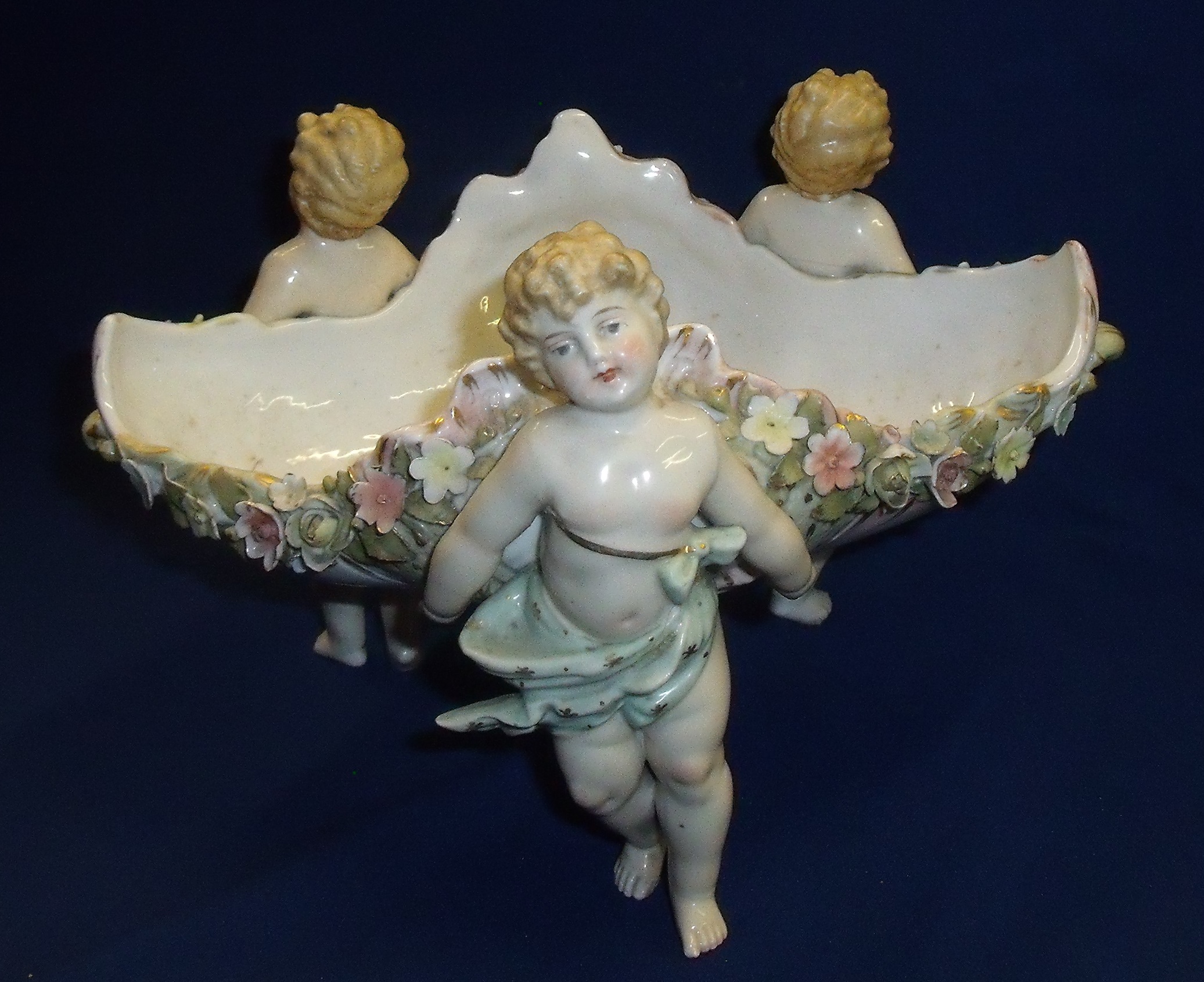 19th C Dresden style decorative bowl supported by three cherub figures and applied flower