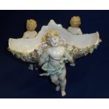 19th C Dresden style decorative bowl supported by three cherub figures and applied flower