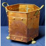 Early to mid 20th C copper twin handled jardiniere raised on three paw feet,