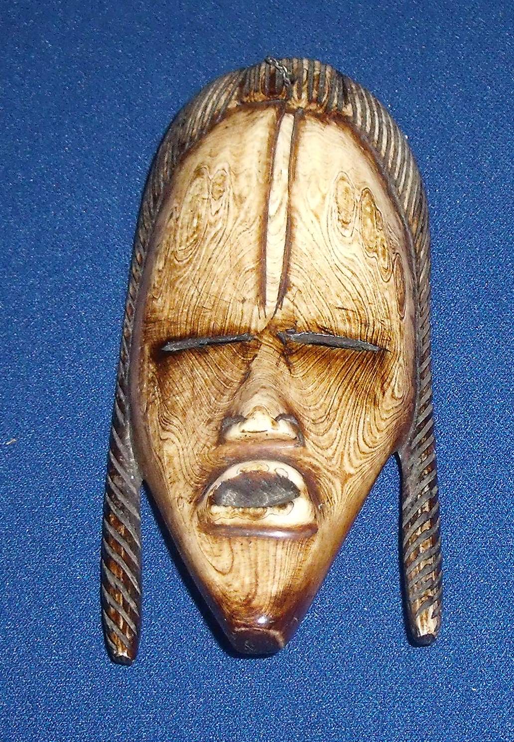 Late 19th C African carved ivory face mask with stained detail (10.