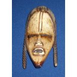 Late 19th C African carved ivory face mask with stained detail (10.