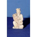 Early 20th C Japanese carved ivory Okimono carving of a elderly gentleman selling fruit (8cm high)
