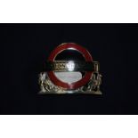 London Transport red enamel cap badge by J.