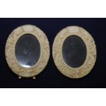 Pair of 19th C carved oriental circular picture frames, the border stylised with dragons,